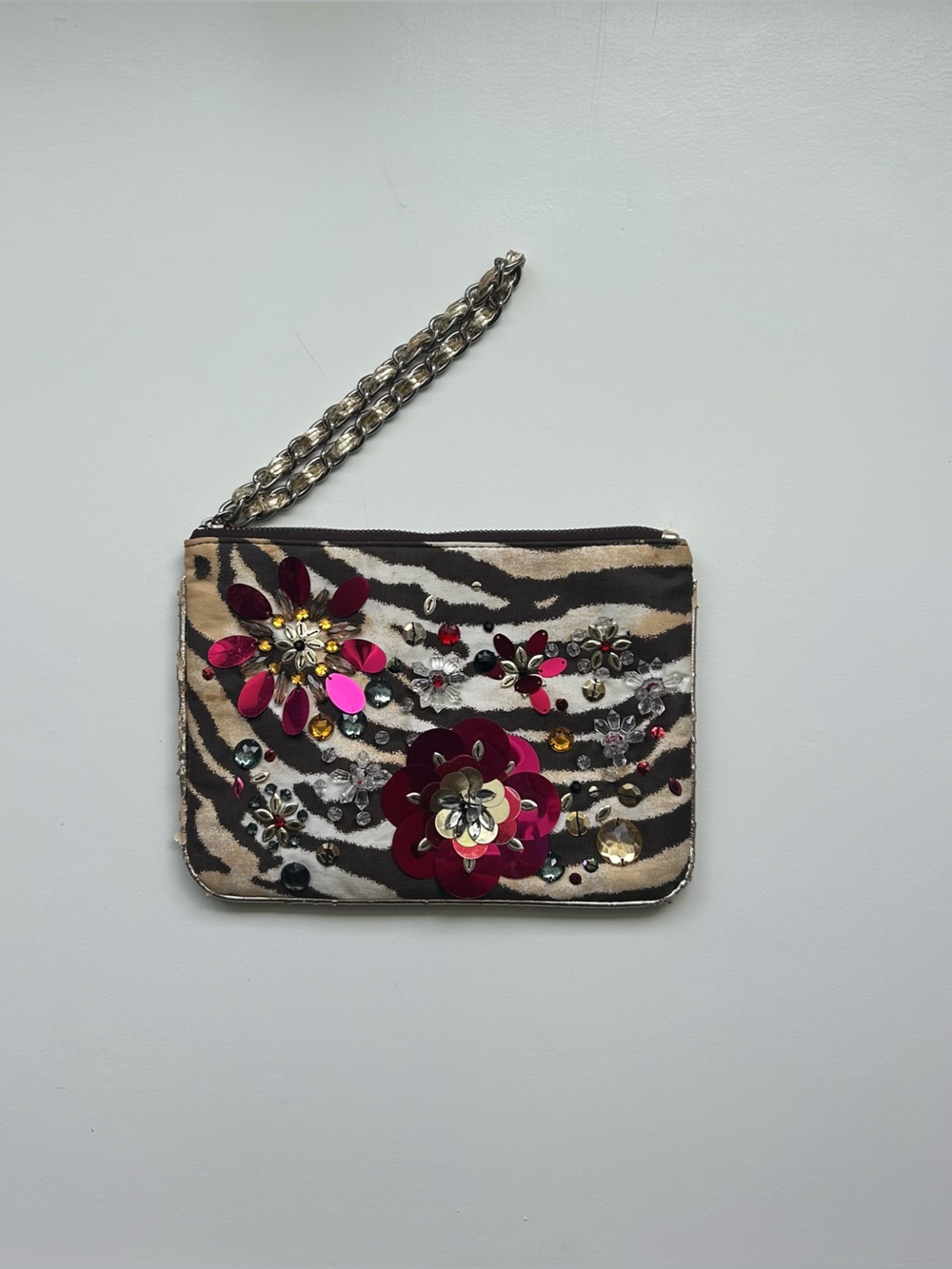 Zebra print wallet with floral embellishments and chain strap